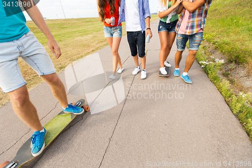 Image of close up of friends with longboards and drinks