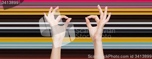 Image of woman hands showing ok sign over blue sky