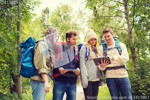 Image of group of friends with backpacks and tablet pc