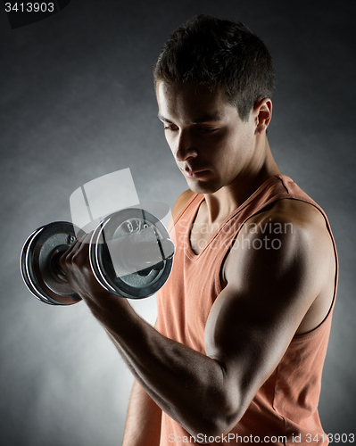 Image of young man with dumbbell