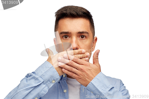 Image of face of man covering his mouth with hand palm