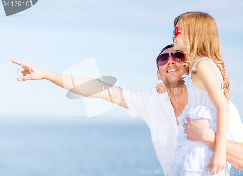 Image of happy father and child in sunglasses over blue sky