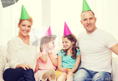 Image of happy family with two kids in hats celebrating