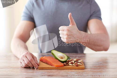 Image of close up of male hands with food rich in protein