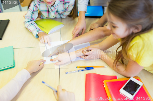 Image of group of school kids pointing fingers to test