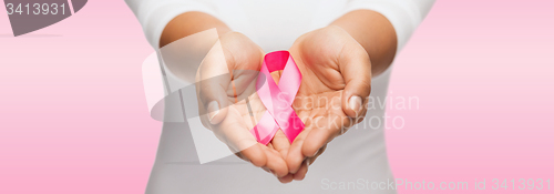 Image of hands holding pink breast cancer awareness ribbon