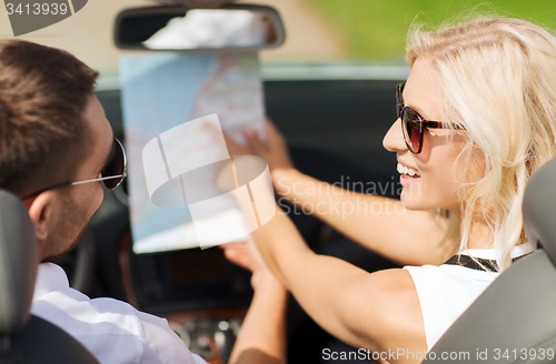 Image of happy man and woman driving in cabriolet car