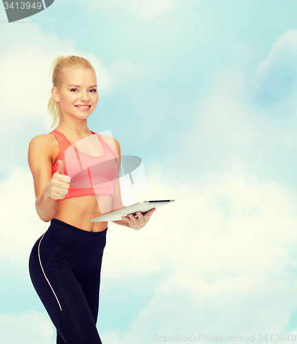 Image of smiling sporty woman with tablet pc computer