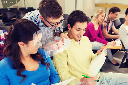 Image of group of smiling students in lecture hall