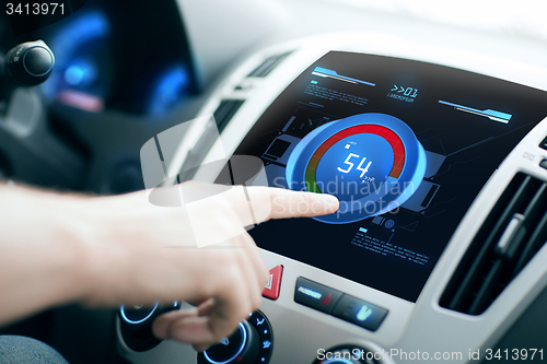 Image of hand setting volume on car audio stereo system