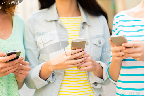 Image of close up of young women with smartphone