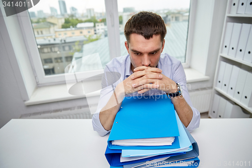 Image of businessman taking papers from secretary in office