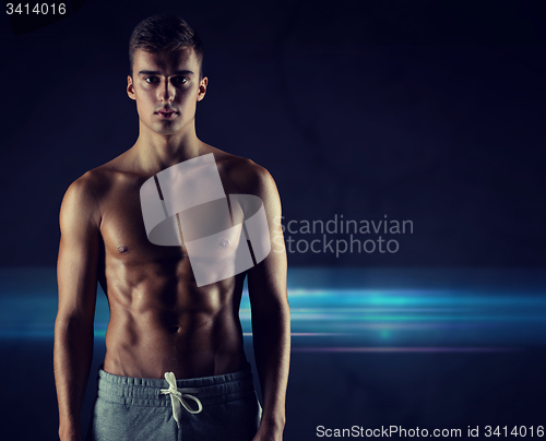 Image of young male bodybuilder with bare muscular torso