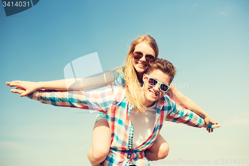 Image of smiling couple having fun outdoors