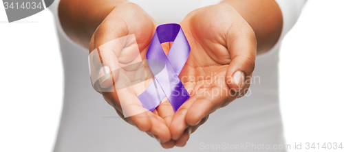 Image of hands holding purple awareness ribbon