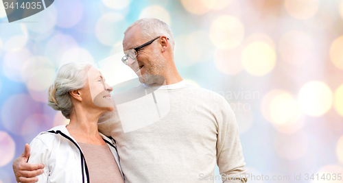 Image of happy senior couple over holidays lights