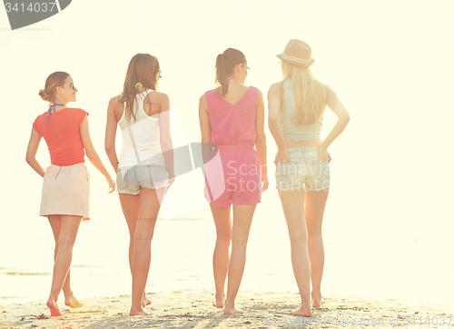 Image of group of young women walking on beach