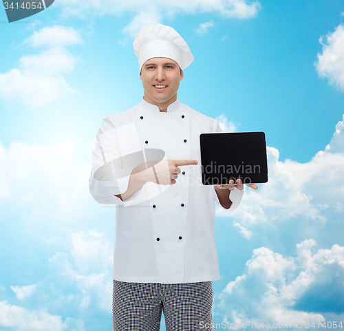 Image of happy male chef cook showing with tablet pc