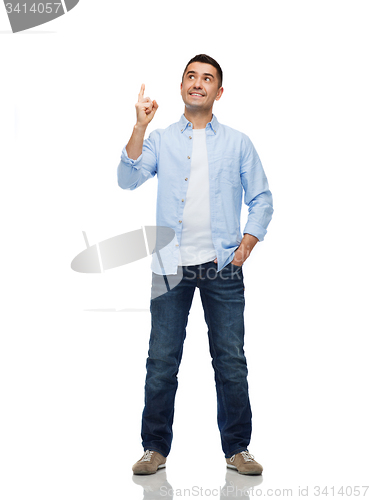 Image of smiling man pointing finger up