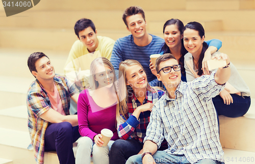 Image of group of students with smartphone and coffee cup