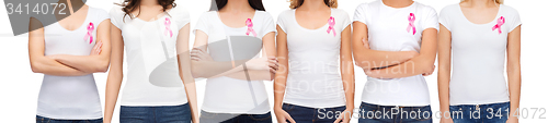 Image of smiling women with pink cancer awareness ribbons