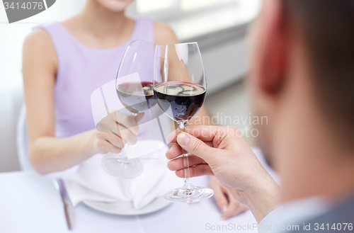Image of young couple with glasses of wine at restaurant