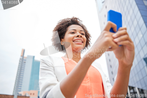 Image of happy african businesswoman with smartphone