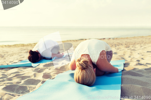 Image of close up of couple making yoga exercises outdoors