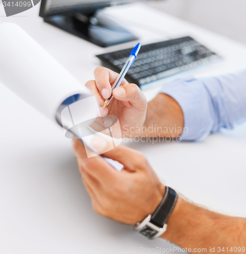 Image of businessman working and signing papers