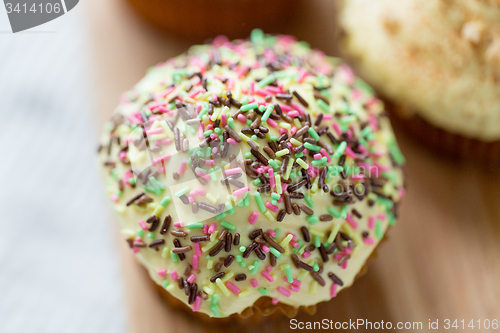 Image of close up of glazed cupcake or muffin on table