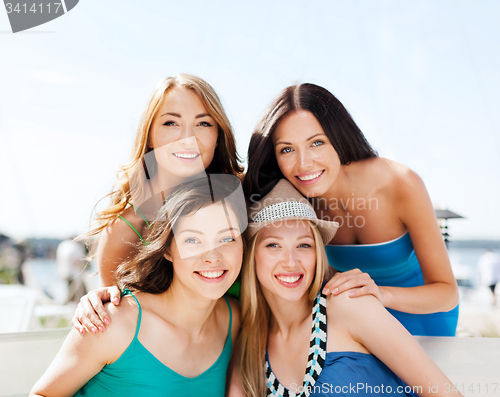 Image of group of girls in cafe on the beach