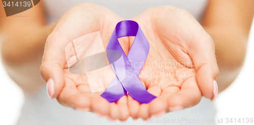 Image of hands holding purple awareness ribbon