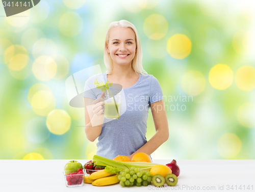 Image of smiling woman drinking juice or shake at home