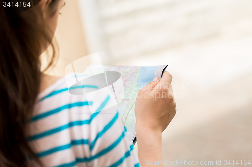 Image of close up of woman reading map