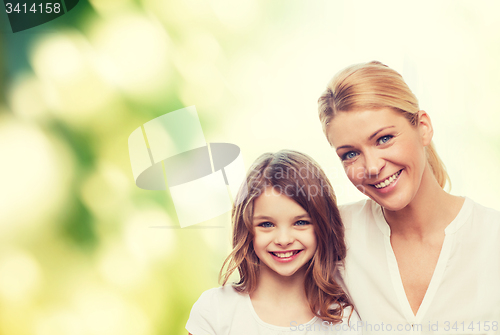 Image of smiling mother and little girl