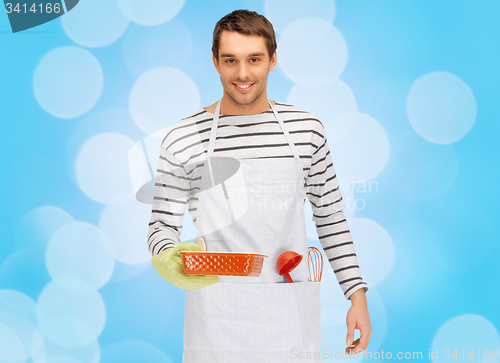 Image of happy man or cook with baking and kitchenware