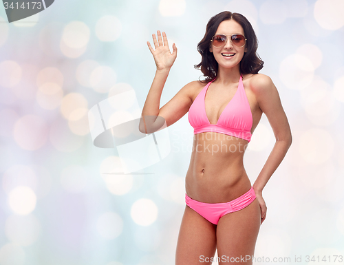 Image of happy woman in sunglasses and bikini swimsuit