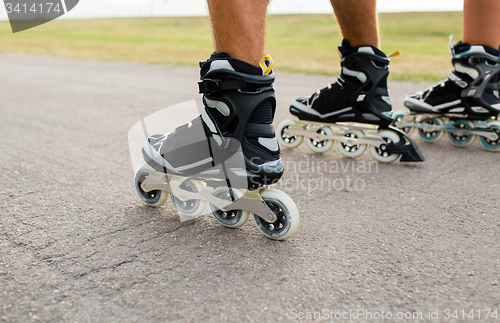 Image of close up of legs in rollerskates skating on road