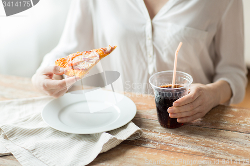 Image of close up of woman with pizza and cola drink