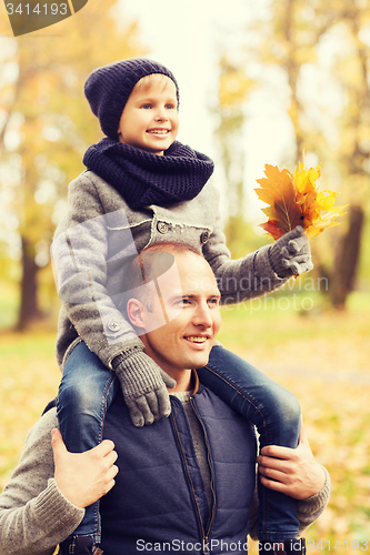 Image of happy family having fun in autumn park