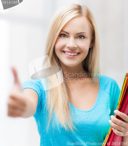 Image of smiling student with folders