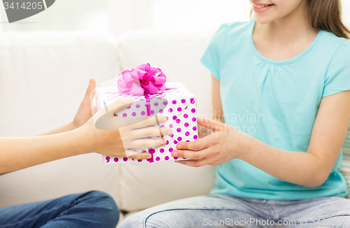 Image of close up of girls with birthday present at home