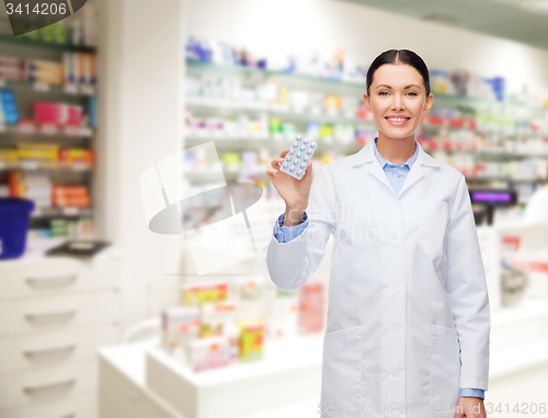 Image of woman pharmacist with pills drugstore or pharmacy