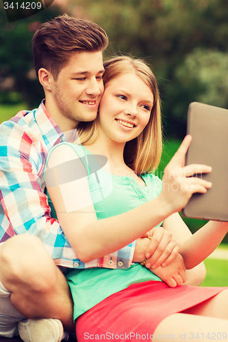 Image of smiling couple with tablet pc making selfie