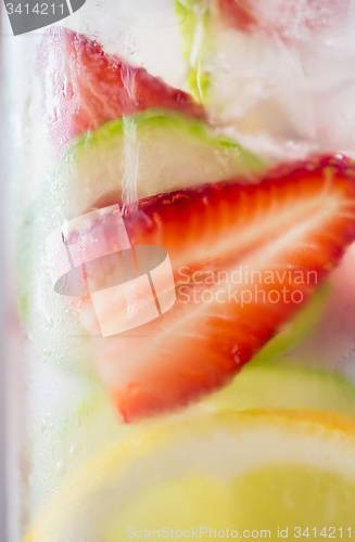 Image of close up of fruit water in glass bottle