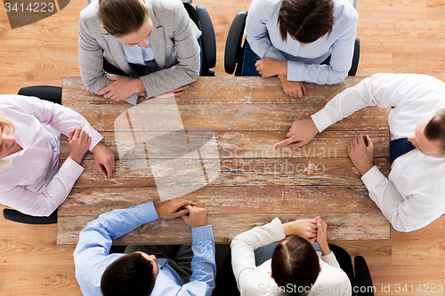 Image of close up of business team sitting at table