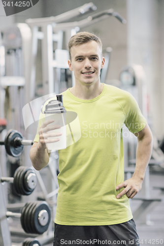 Image of smiling man with protein shake bottle