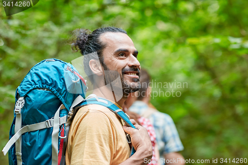 Image of group of smiling friends with backpacks hiking