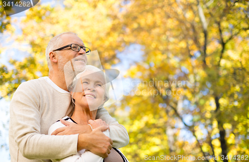 Image of happy senior couple in autumn park