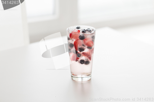 Image of close up of fruit water with ice cubes in glass